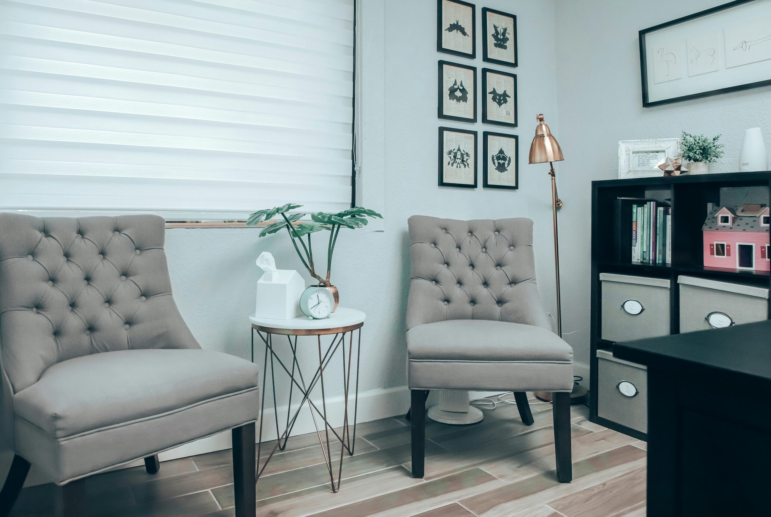 A stylish living room with elegant chairs, decor, and a bookshelf in a modern setting.